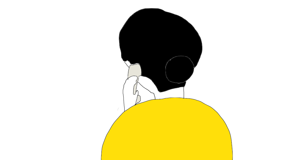 内線電話をする背中